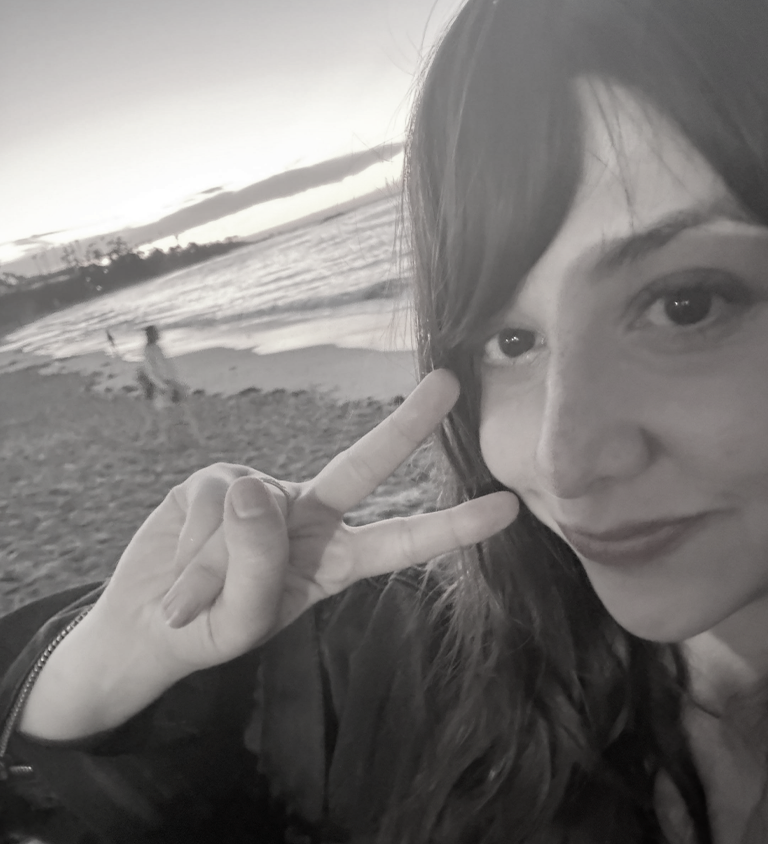 Black and white beach selfie of the two artists.